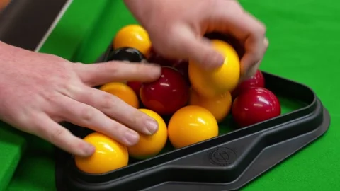 Racking balls in triangle in blackball Pool game on a green cloth pool table Stock Footage 297872232