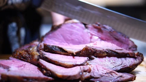 Racking Focus between slices of roast beef and hands carving meat, CLOSE UP Stock Footage 103055639