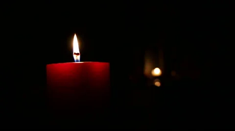 Racking focus shot of candles burning in a dark room Stock Footage 47915236