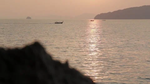 Racking focus shot of sunset and rocky shore Stock Footage 51022266