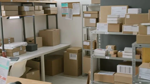 Racks and Shelves with Assorted Parcels at Courier Delivery Office Stock Footage 321433294
