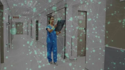 Rad tech entering corridor, examining X-ray while walking for diagnosis, teal Stock Footage 331832589