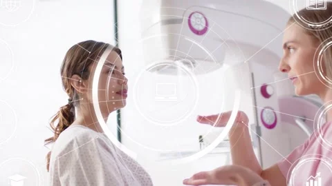 Rad tech gesturing, guiding patient for mammo while tuning paddle aligning plate Stock Footage 330646503