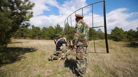Radar base. A soldier adjusts the radar. The commander says something to him Stock Footage 128600528