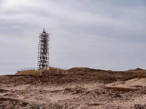 A radar tower under construction on a high desert hill. Stock Photos