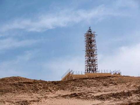 A radar tower under construction on a high desert hill. Stock Photos