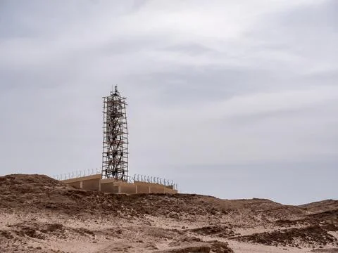 A radar tower under construction on a high desert hill. Stock Photos