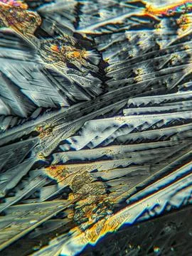Radial crystal structures under polarized microscope with colorful edge Stock Photos