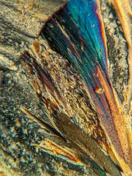 Radial crystal structures under polarized microscope with colorful edge Stock Photos