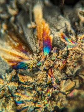 Radial crystal structures under polarized microscope with colorful edge Stock Photos