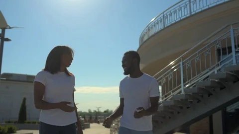 Radiant colleagues walking and taking selfies together Stock Footage