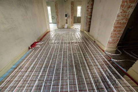 Radiant floor heating system with plastic pipes secured to insulation panels  Stock Photos