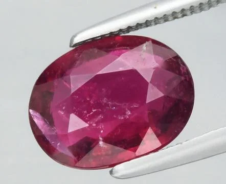 Radiant Oval Cut Pink Ruby Gemstone Displayed with Precision Stock Photos
