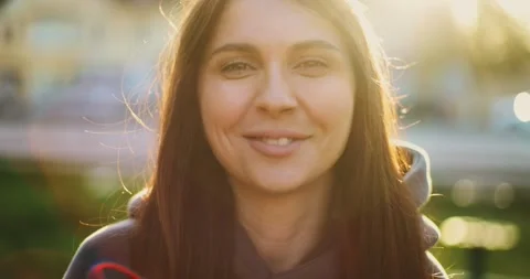 A Radiant Smile Captured in the Glow of Sunset: Celebrating Moments of Joy and Stock Footage 344808005