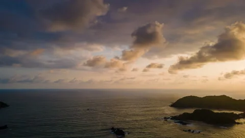 Radiant Sunset Over the Ocean with Vibrant Sky and Coastal Silhouettes Stock Footage 301454426