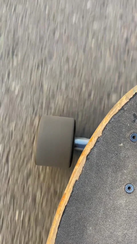 Radiant wheel turning smoothly along textured roadway in sunlight Видео 336434863