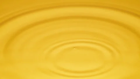 Radiant Yellow Drop Transforms Into Circular Ripples, High Contrast Illumination Video stock 329276509