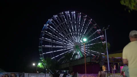 Radiating rainbow spirals of light on a ferris wheel in a foggy night. Stock Footage 157969715