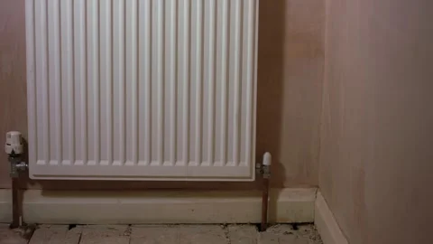Radiator on fresh plaster room wall Stock Footage 345910814