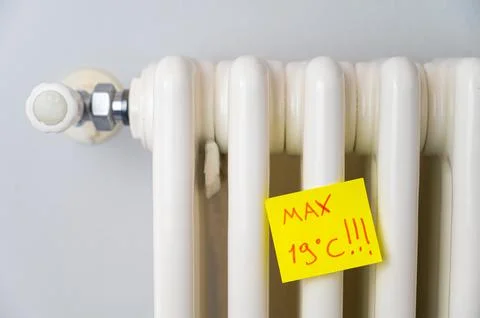 Radiator with ticket and text "max 19 ° C". Stock Photos