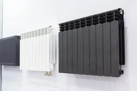 Radiators on the showcase of the hardware store Stock Photos