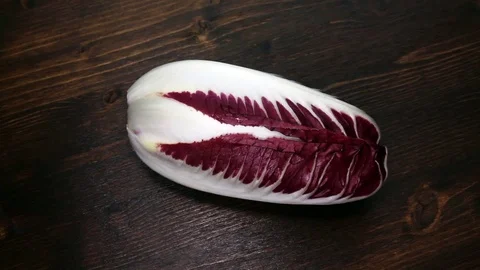 Radicchio on wooden table Stock Footage 86523498