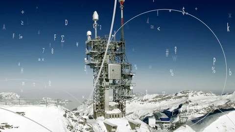 Radio antenna on mountain peak in wintertime with data streaming animation Видео 86855260