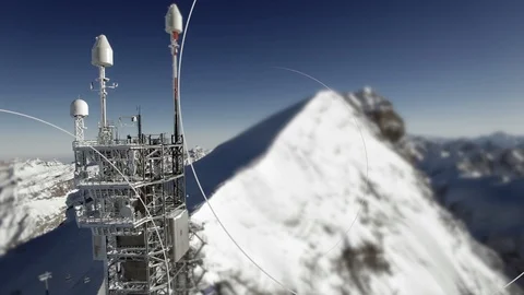 Radio antenna on mountain peak in wintertime with data streaming animation Stock Footage 86855262