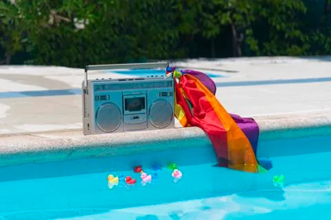 Radio cassette with pride flag at the poolside Stock Photos