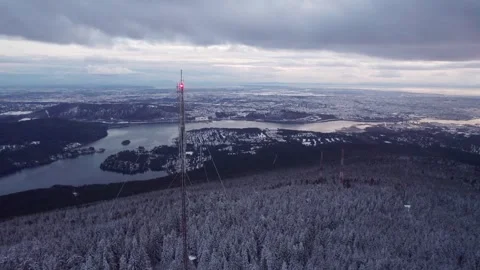 Radio cell tower in a winter forest with snow covered trees, 5g transmission Stock Footage 245953654
