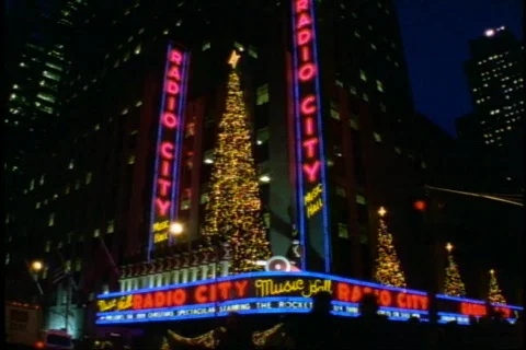 Radio City Music Hall at Christmas, nighttime with traffic, crowds, marquee Stock Footage