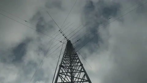Radio communications tower looking upwards at antennas and moving clouds, 4k Stock Footage 141382307