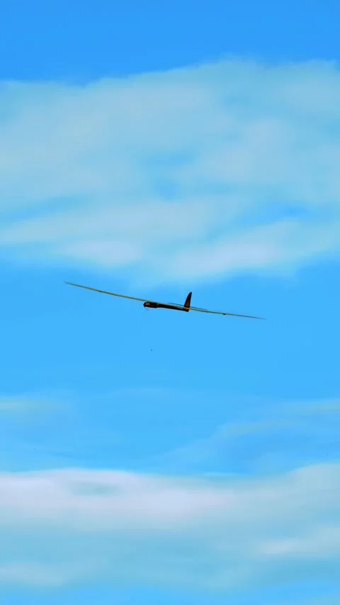 Radio Controlled Glider Soaring High in the Clear Blue Sky, Symbolizing Freedom Stock Footage 313729732