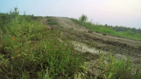 Radio-controlled machine rides on the puddle. Spray are flying into the camera Video stock 71755075