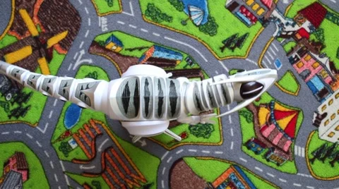 Radio-controlled toy dinosaur moves on the carpet Stock Footage 61769552