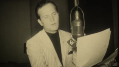 Radio host with script speaking into microfilm at WLAC radio station in Nashvill Stock Footage 248396326