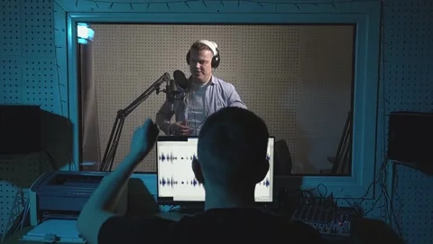 Radio host speaks into microphone in studio Video stock 239436557