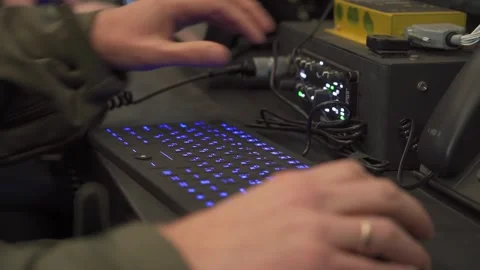 Radio operator adjusting transceiver and typing on illuminated keyboard Stock-Footage 321680403