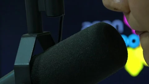 Radio presenter is reading text to microphone Video stock 329393157