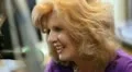Radio show host at her microphone face lighting up with laughter HD Footage