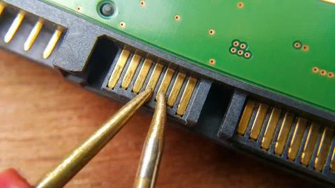 The radio technician repairs a part of the computer Stock Photos