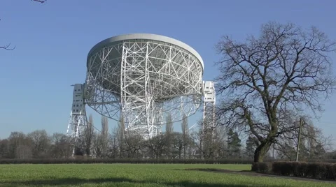 Radio telescope deep space observatory jodrell bank blue sky Stock Footage 65375593