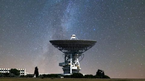 Radio telescope on the night starry sky background, science  time lapse scene Stock Footage