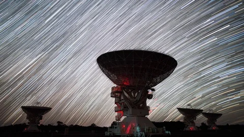 Radio Telescopes Moving in Sync While the Milky Way Creating Beautiful Trails Stock Footage 100354448