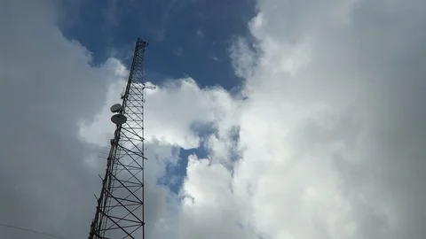 Radio tower. Cumulus clouds pass overhead Stock Footage 112783595