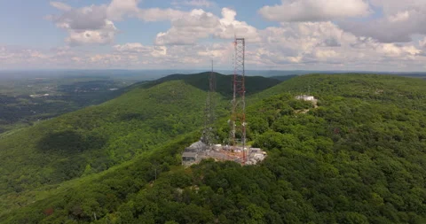 Radio Towers fly around on Mount Beacon in New York show valley and Hudson River Stock Footage 346412740
