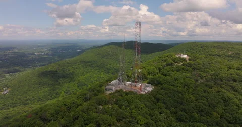 Radio Towers fly around on Mount Beacon in New York show valley and Hudson River Stock Footage 346412743