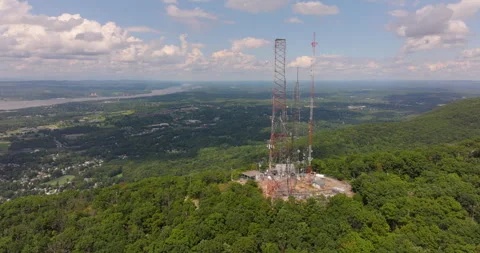 Radio Towers fly around on Mount Beacon in New York show valley and Hudson River Stock Footage 346412744