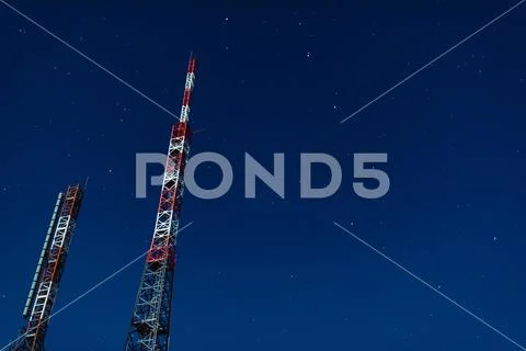 Radio transmission antennas on the starry sky - media broadcasting concept Stock Photos