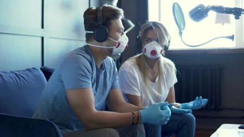 Radio worker having interview with guest in recording studio during pandemic Stock-Footage 233624956